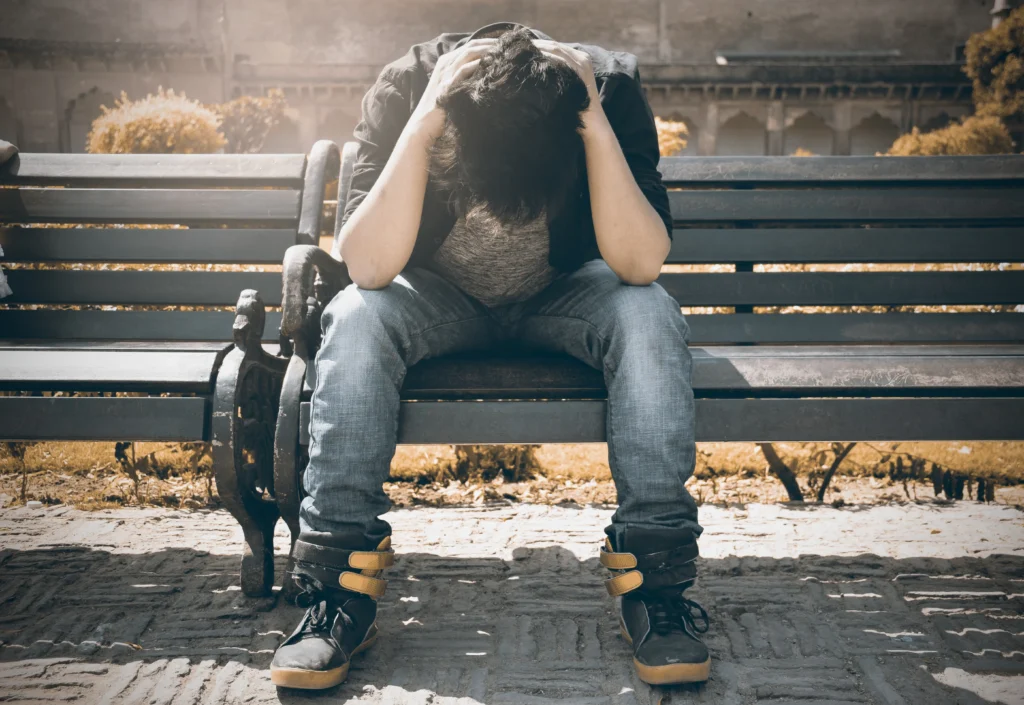 Man sitting alone reflecting on micro traumas and emotional stress