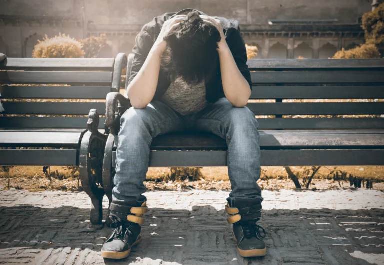 Man sitting alone reflecting on micro traumas and emotional stress